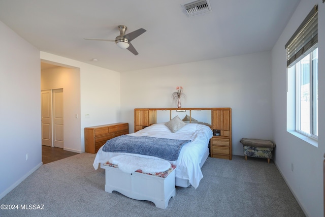 bedroom featuring dark carpet and ceiling fan