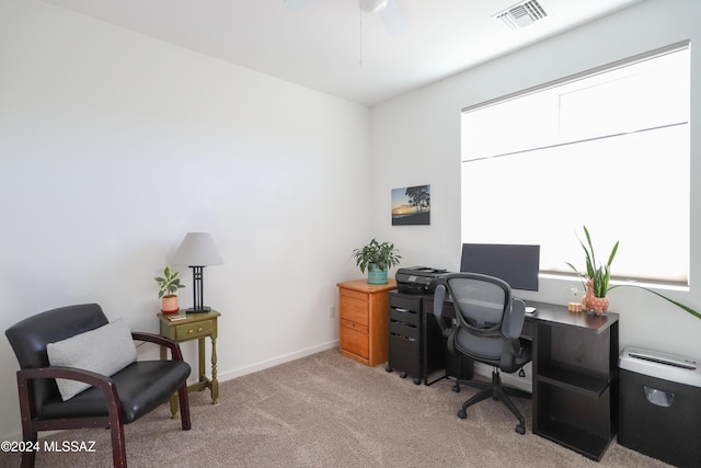 office space featuring light carpet and ceiling fan