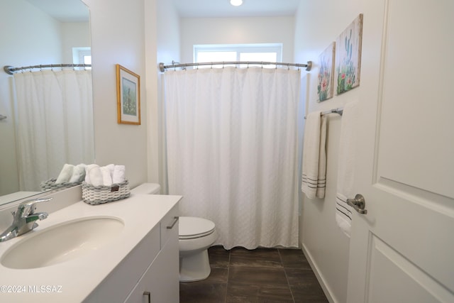 bathroom with walk in shower, vanity, wood-type flooring, and toilet