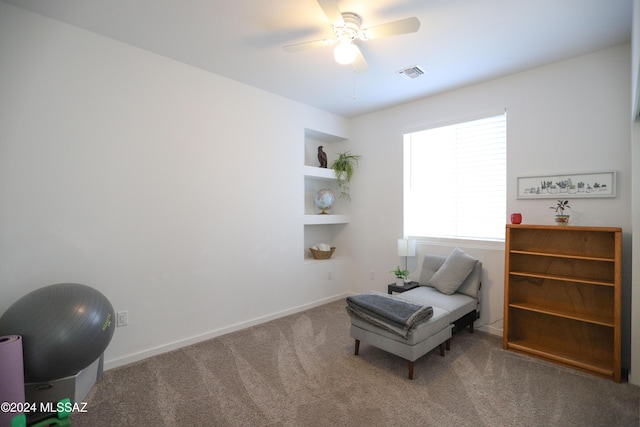 living area with carpet flooring and ceiling fan