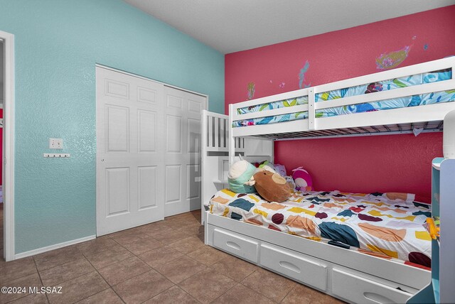 tiled bedroom featuring a closet