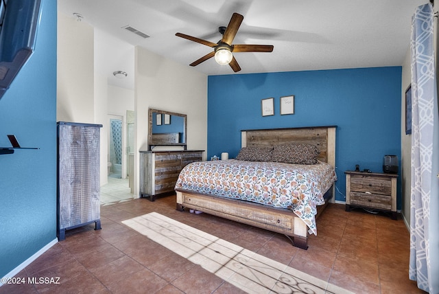 tiled bedroom featuring lofted ceiling, connected bathroom, and ceiling fan