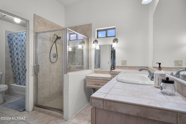 bathroom with vanity, toilet, a shower with shower door, and tile patterned flooring