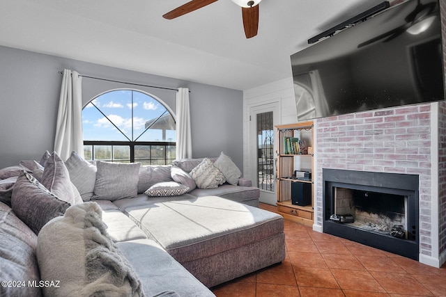 living room featuring ceiling fan and tile patterned floors