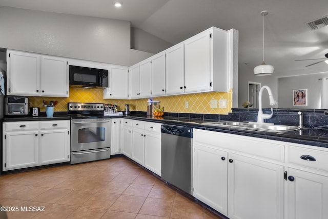 kitchen featuring sink, white cabinetry, tile patterned flooring, stainless steel appliances, and decorative light fixtures