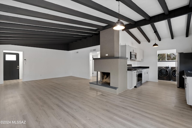 unfurnished living room featuring beam ceiling, washer and clothes dryer, high vaulted ceiling, and light hardwood / wood-style floors