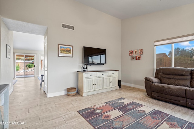 living area with visible vents, baseboards, and light wood-style floors