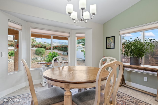 dining area featuring a wealth of natural light, baseboards, an inviting chandelier, and vaulted ceiling