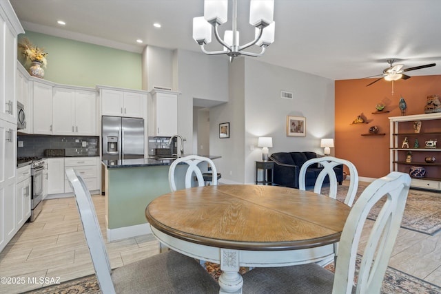 dining area featuring recessed lighting, ceiling fan with notable chandelier, visible vents, and wood tiled floor