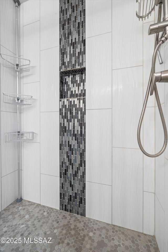 full bath with a tile shower