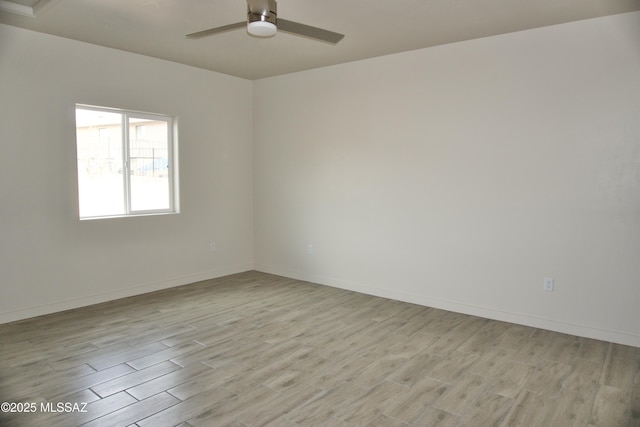 spare room featuring ceiling fan and light hardwood / wood-style flooring