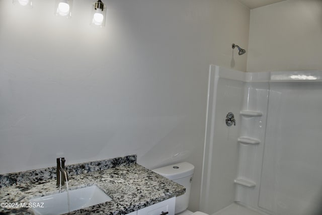 bathroom with vanity, toilet, and walk in shower