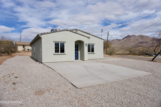 view of front facade with a mountain view and a patio