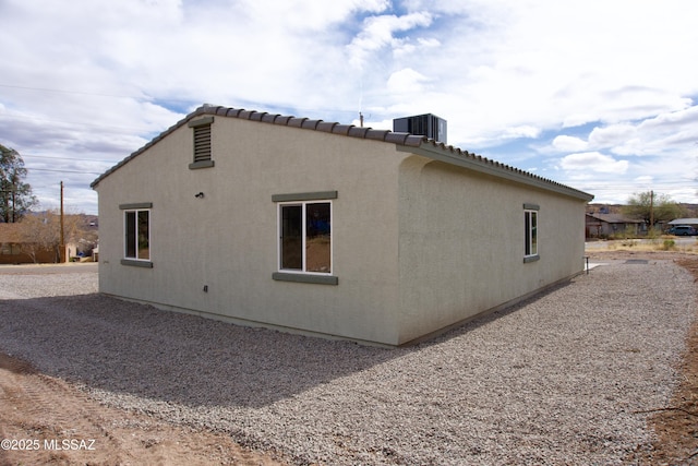 view of home's exterior with central AC