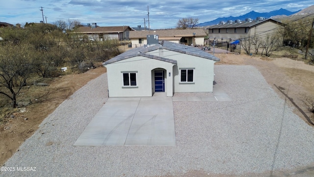 view of front facade featuring a patio and a mountain view