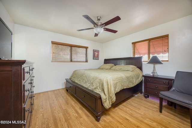 bedroom with ceiling fan and light hardwood / wood-style flooring