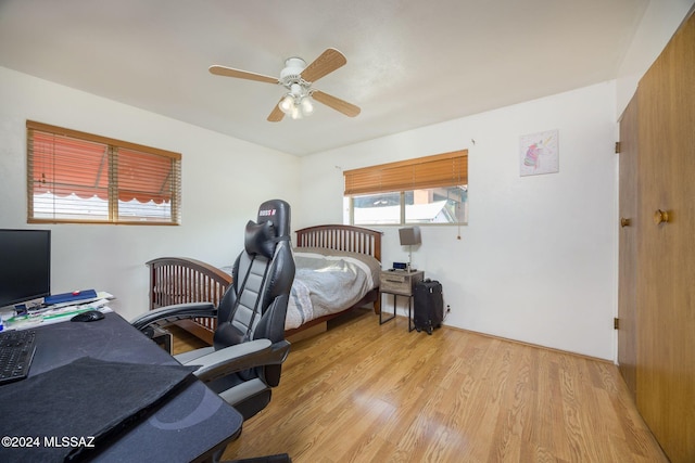 bedroom with ceiling fan and light hardwood / wood-style floors