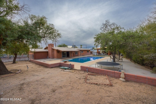 view of pool featuring a patio and a trampoline