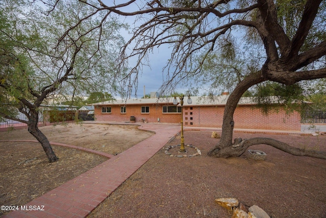 1440 W Roller Coaster Rd, Tucson, AZ 85704 - back of house with brick siding and a patio