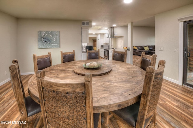 dining area with light hardwood / wood-style floors