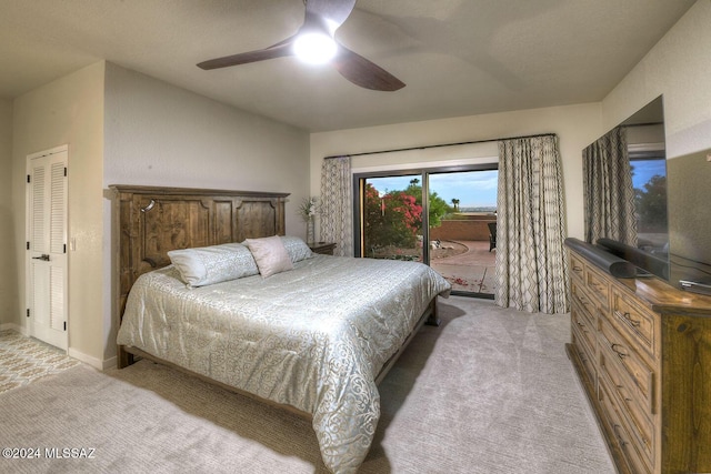 bedroom with access to exterior, light colored carpet, and ceiling fan