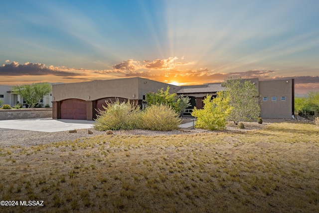 pueblo-style house with a garage