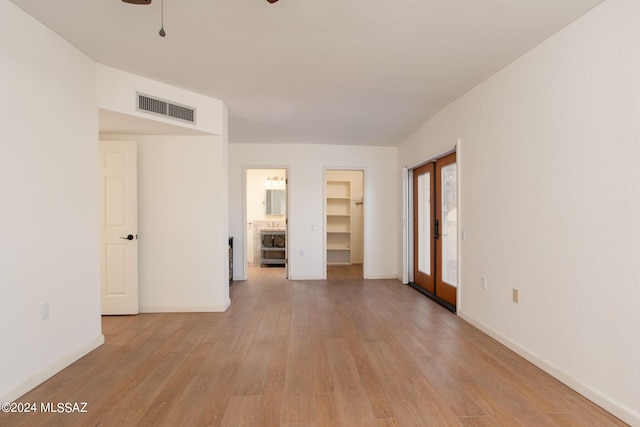 spare room featuring ceiling fan and light hardwood / wood-style floors