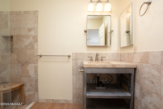 bathroom with vanity and tile walls