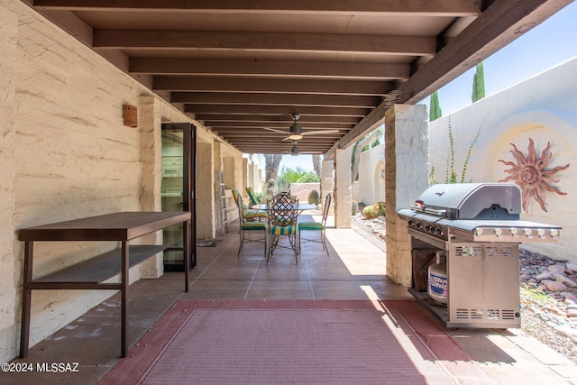 view of patio with ceiling fan and area for grilling