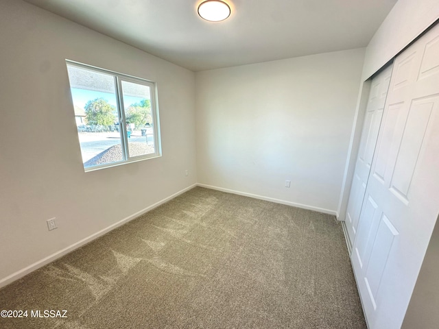 unfurnished bedroom with carpet and a closet