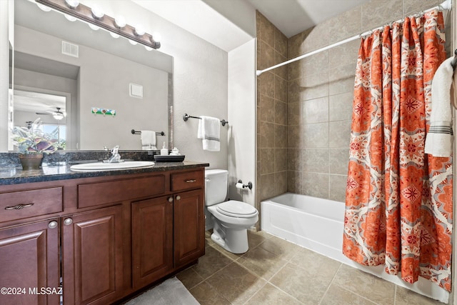 full bathroom featuring vanity, tile patterned flooring, ceiling fan, toilet, and shower / tub combo with curtain