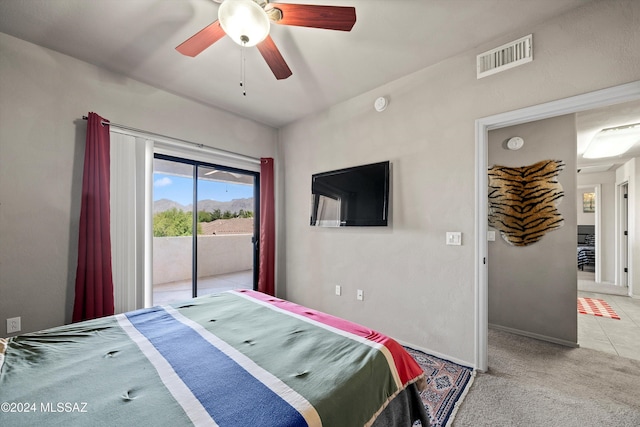 carpeted bedroom with ceiling fan and access to outside