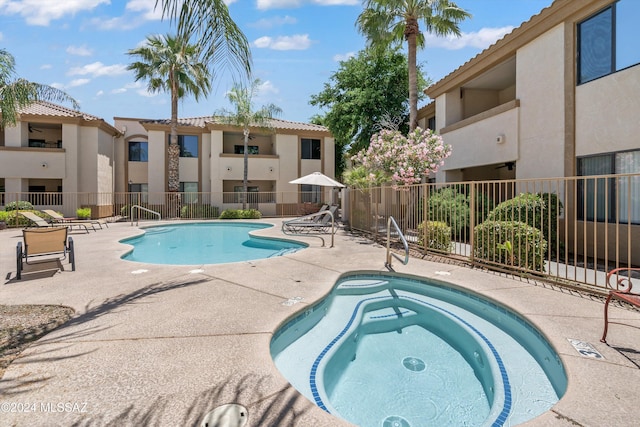 view of pool featuring a patio and a hot tub