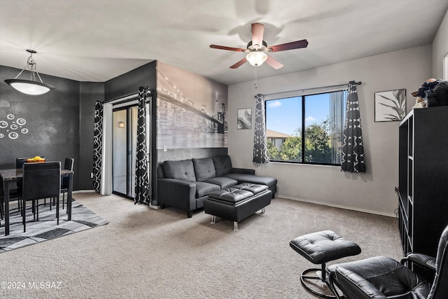 carpeted living room featuring ceiling fan