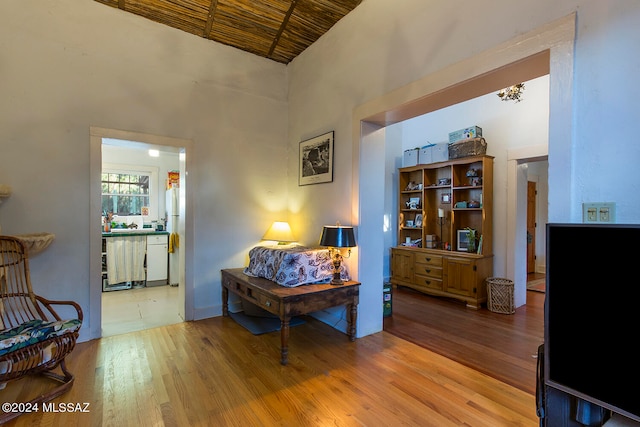 living area featuring wood-type flooring and a high ceiling