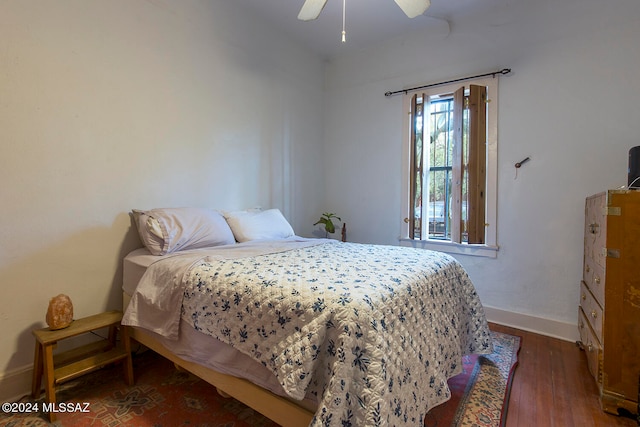 bedroom with ceiling fan and dark hardwood / wood-style flooring