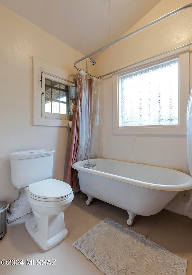 bathroom featuring tile patterned flooring, shower / bath combination with curtain, toilet, and lofted ceiling