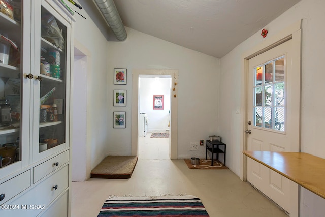 interior space featuring washer / clothes dryer and lofted ceiling