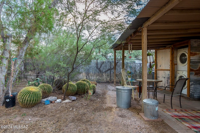 view of yard with a patio and stacked washer / drying machine