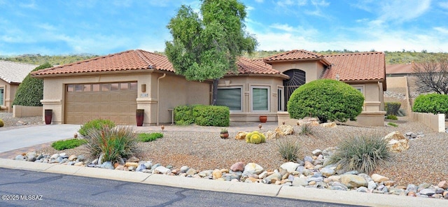 mediterranean / spanish-style house with a garage