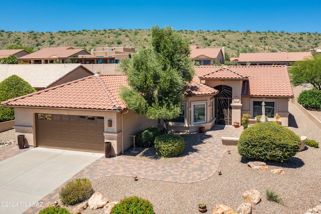 mediterranean / spanish-style house featuring a garage