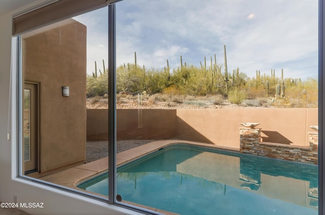 view of swimming pool with a fenced in pool