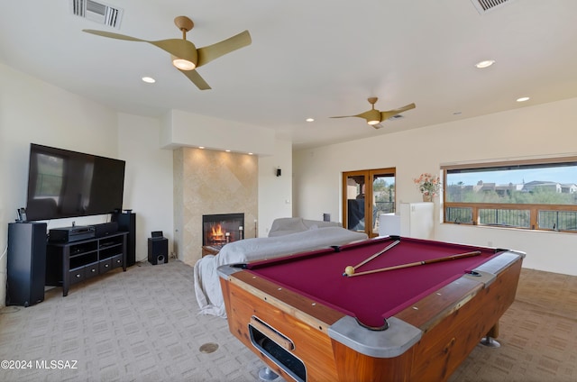 playroom with ceiling fan, billiards, a high end fireplace, and light carpet