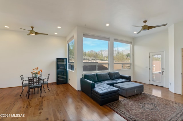 living room with wood-type flooring and ceiling fan