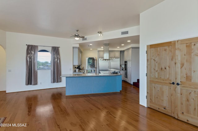 4423 N Osage Dr, Tucson, AZ 85718 - kitchen featuring visible vents, wood finished floors, ventilation hood, a ceiling fan, and gray cabinetry