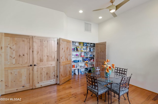 dining area featuring wood-type flooring and ceiling fan