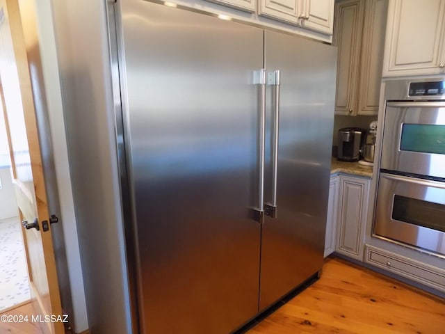 kitchen featuring stainless steel appliances and light wood finished floors