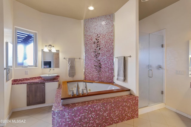 bathroom featuring tile patterned flooring, a jetted tub, a shower stall, and vanity