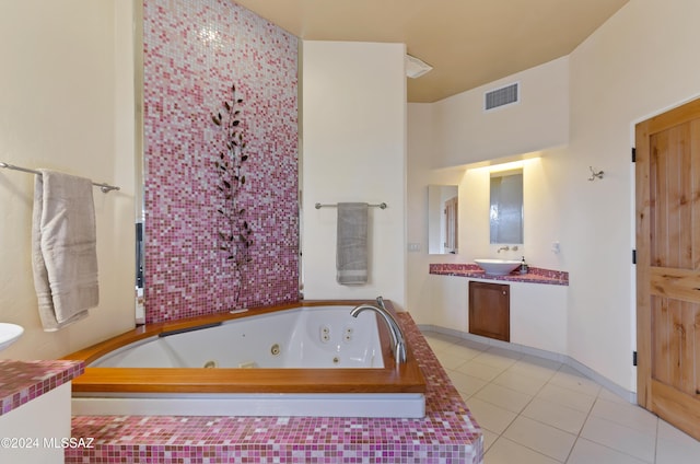 bathroom with visible vents, vanity, a whirlpool tub, and tile patterned floors