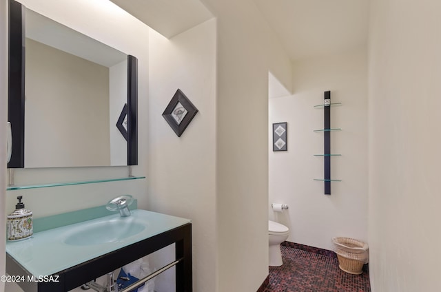 bathroom with vanity, toilet, and tile patterned flooring